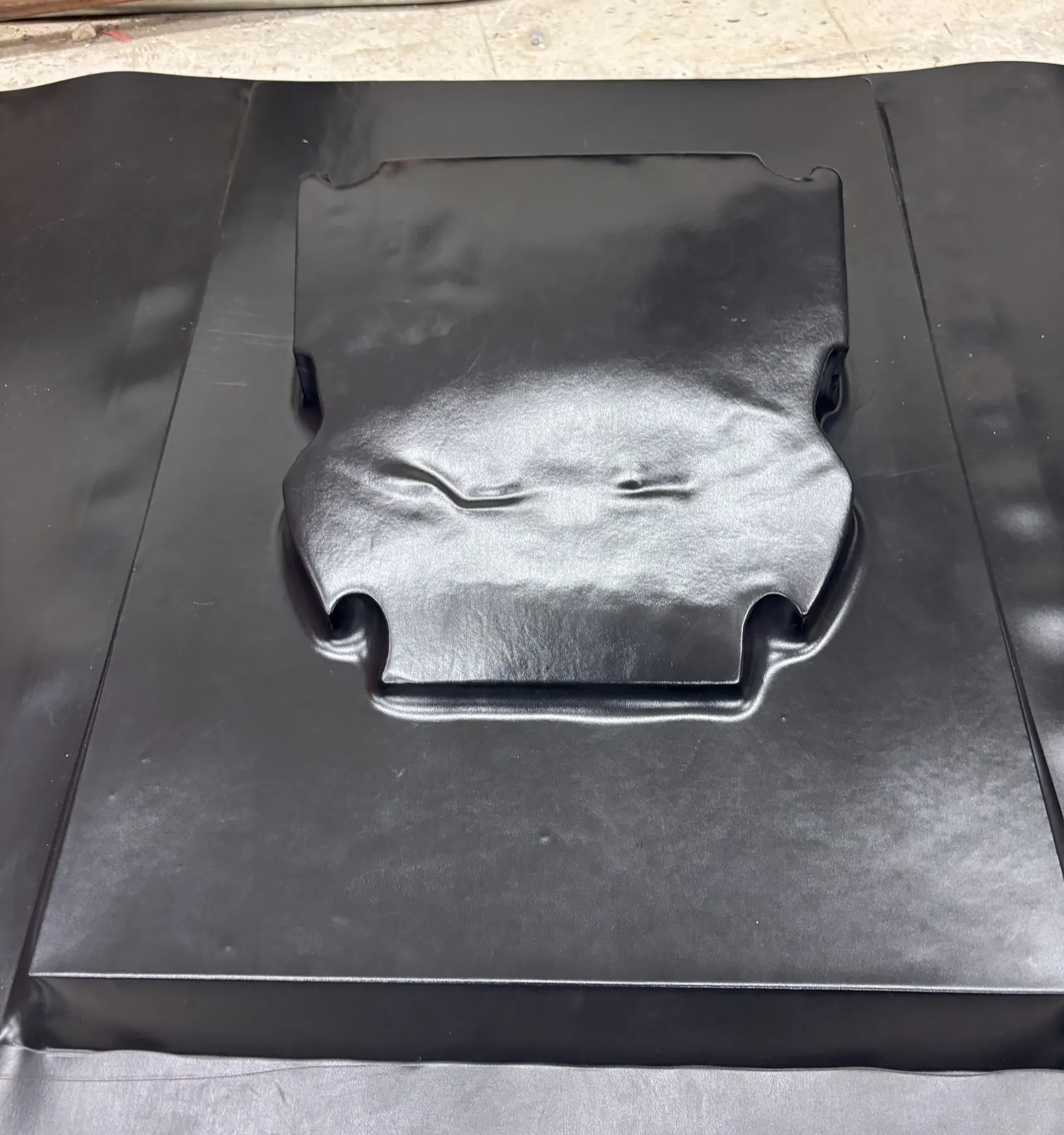 The formed sheet from above. The mold's notched outline shows through.